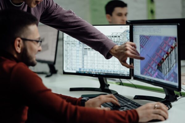 Engineers examining product design on computer